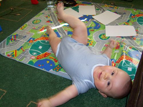 Happy Little Man lying on the playmat before painting